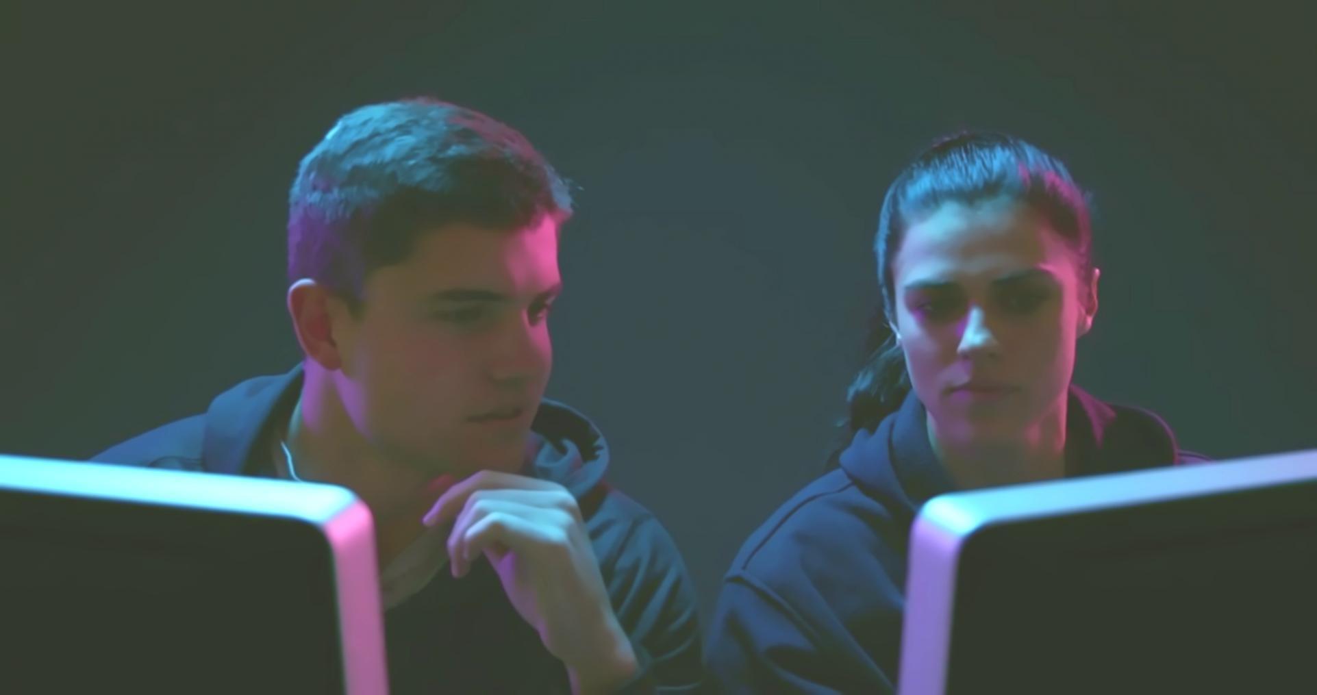 Software testing team reviewing code quality metrics on multiple monitors